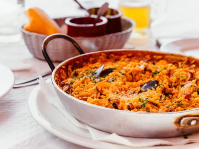 Spanish Seafood Paella with mussels, shrimps etc. in a steel paella pan. Canary islands cousine in a small family restaurant